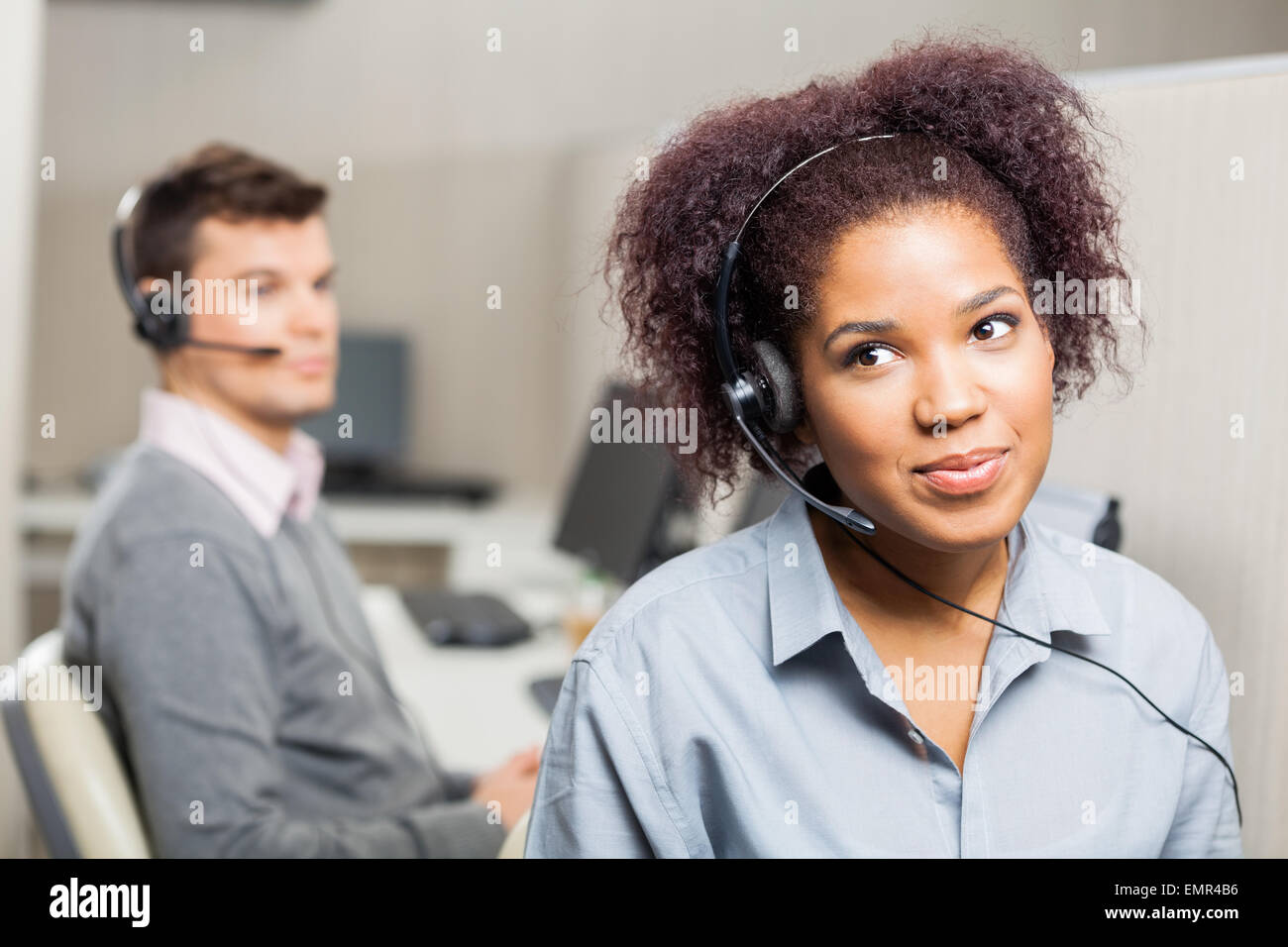 Female Customer Service Representative Wearing Headset In Office Stock ...