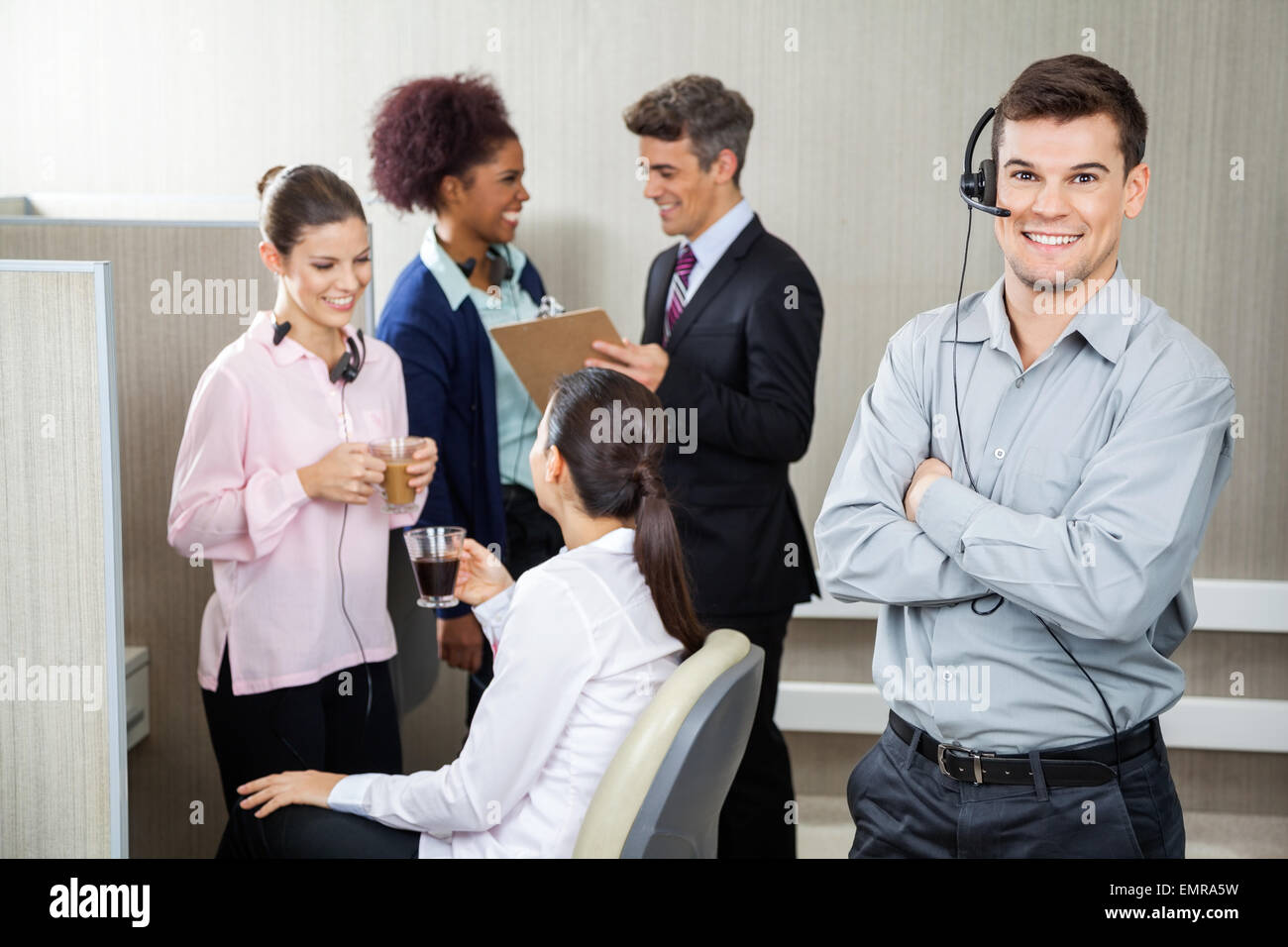 Smiling Customer Service Representative Standing Arms Crossed Stock