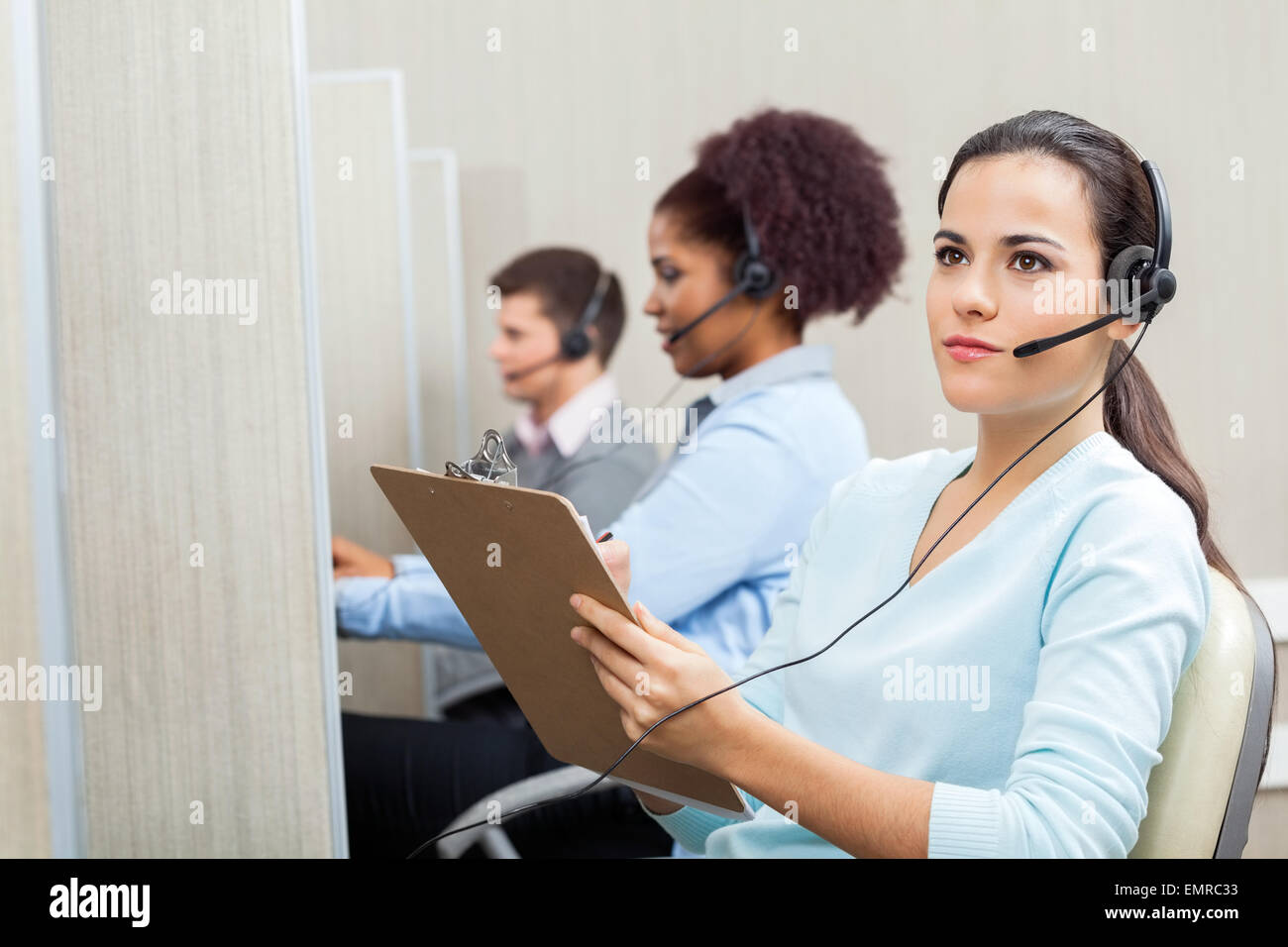 Thoughtful Female Customer Service Agent Holding Clipboard Stock Photo Alamy