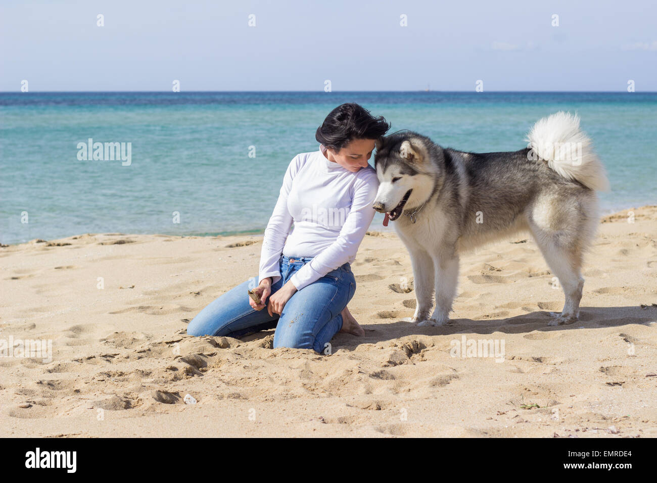 woman girl dog pet husky hug love beach sea ocean spring happy fun tenderness Stock Photo