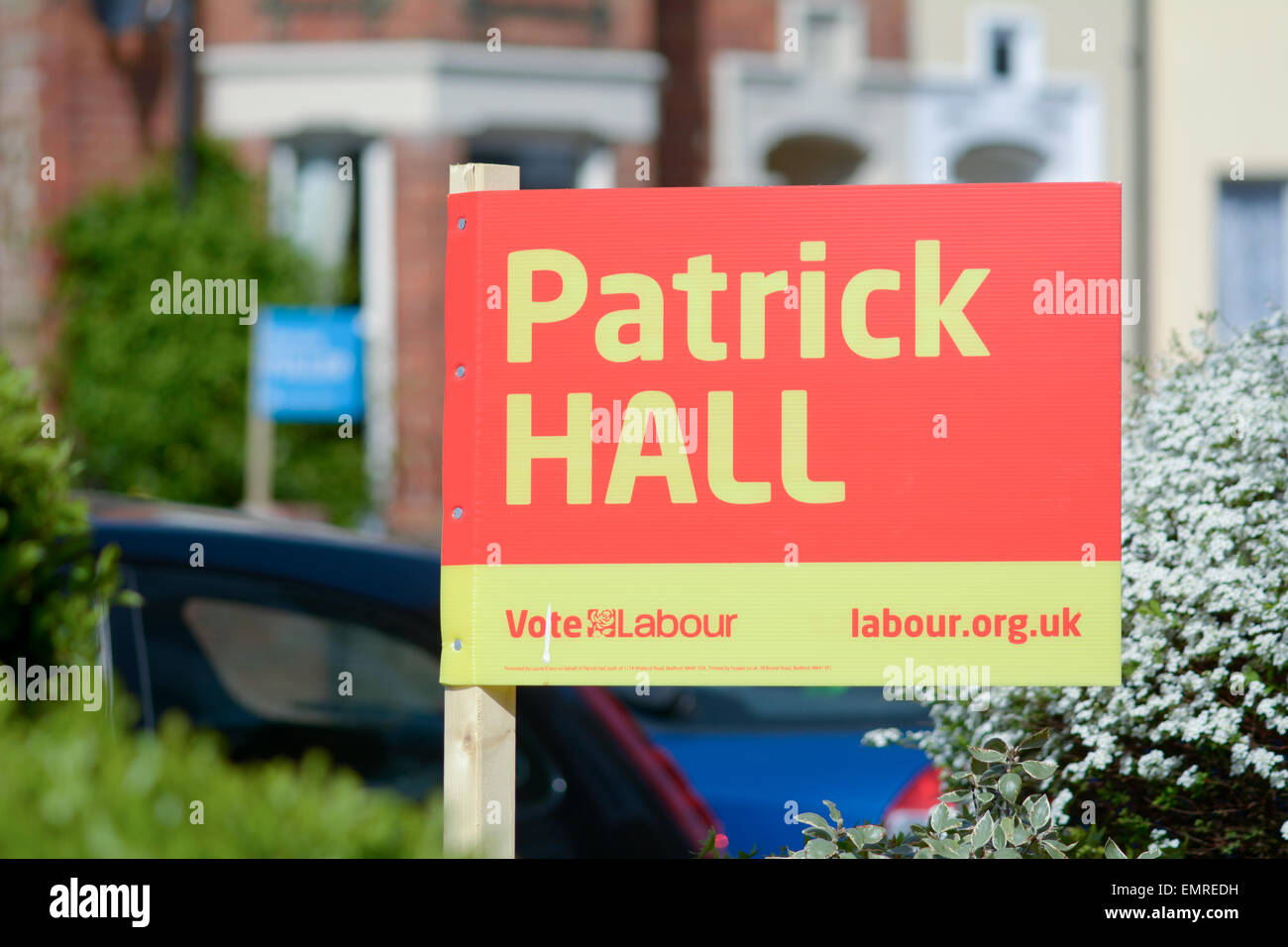 Labour Political Party poster outside house with Conservative party poster in background in Bedford, Bedfordshire, England Stock Photo