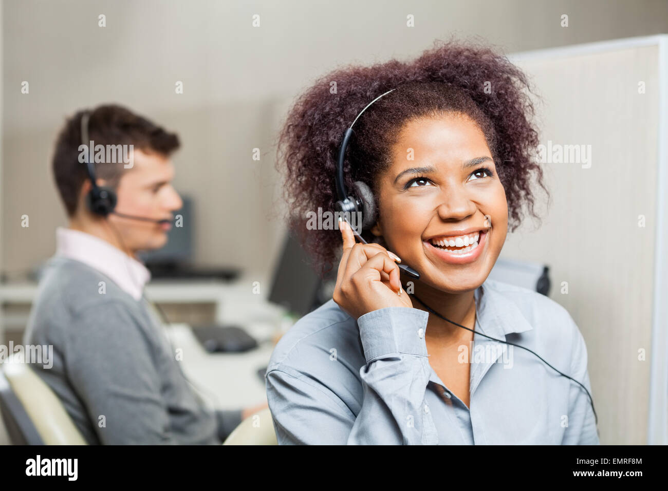 Cheerful Female Customer Service Representative In Office Stock Photo