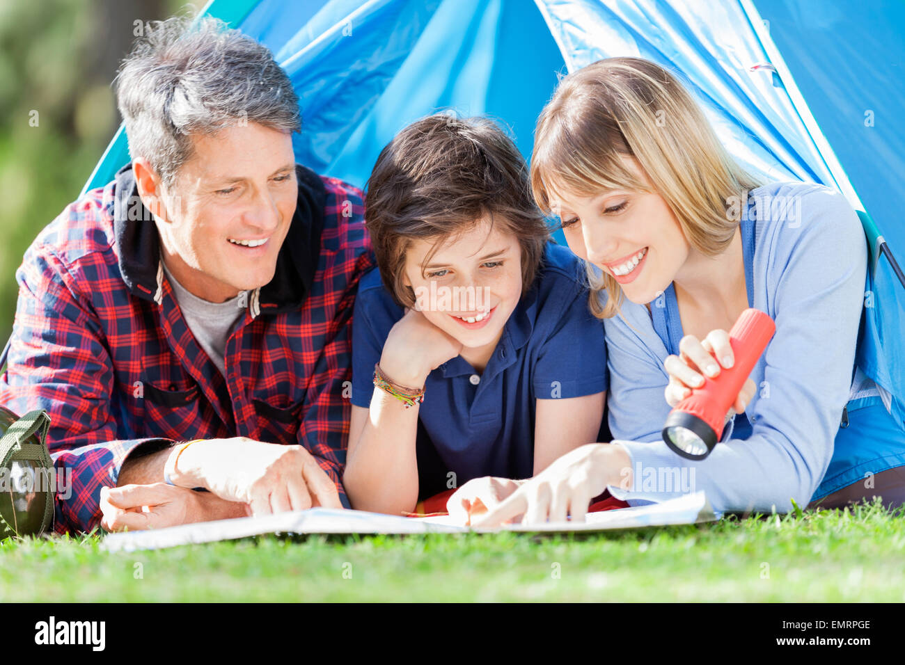 Family Looking At Map In Tent Stock Photo