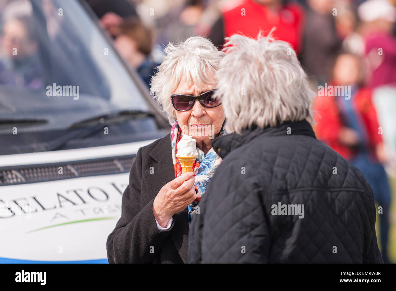 A woman eating an ice cream at Framlingham Country Show in Framlingham , Suffolk , England , Britain , Uk Stock Photo