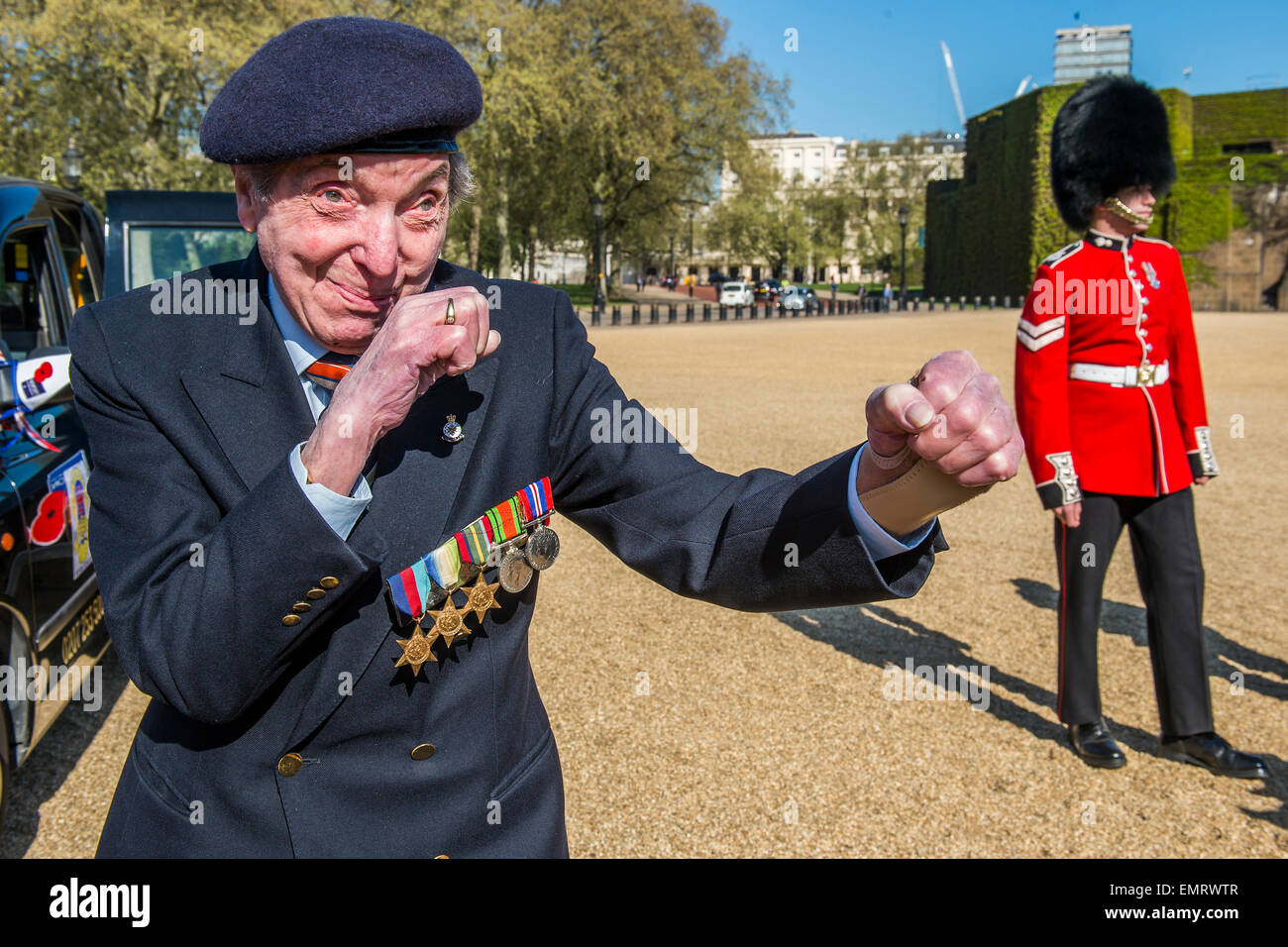 Peter Kent, 90 Royal Navy, show off his boxing skills - Second World War Veterans and serving Guardsmen on Horse Guards Parade Ground to highlight Royal British Legion events on Victory in Europe (VE) Day. The Legion is also announcing that veterans and their carers will receive funding towards attending the event on the weekend of the 8-10th May.  Places will be available for a series of commemorative events over the weekend including on VE Day itself, Friday 8 May, when a Service of Remembrance will be held at The Cenotaph, with a national two min Stock Photo