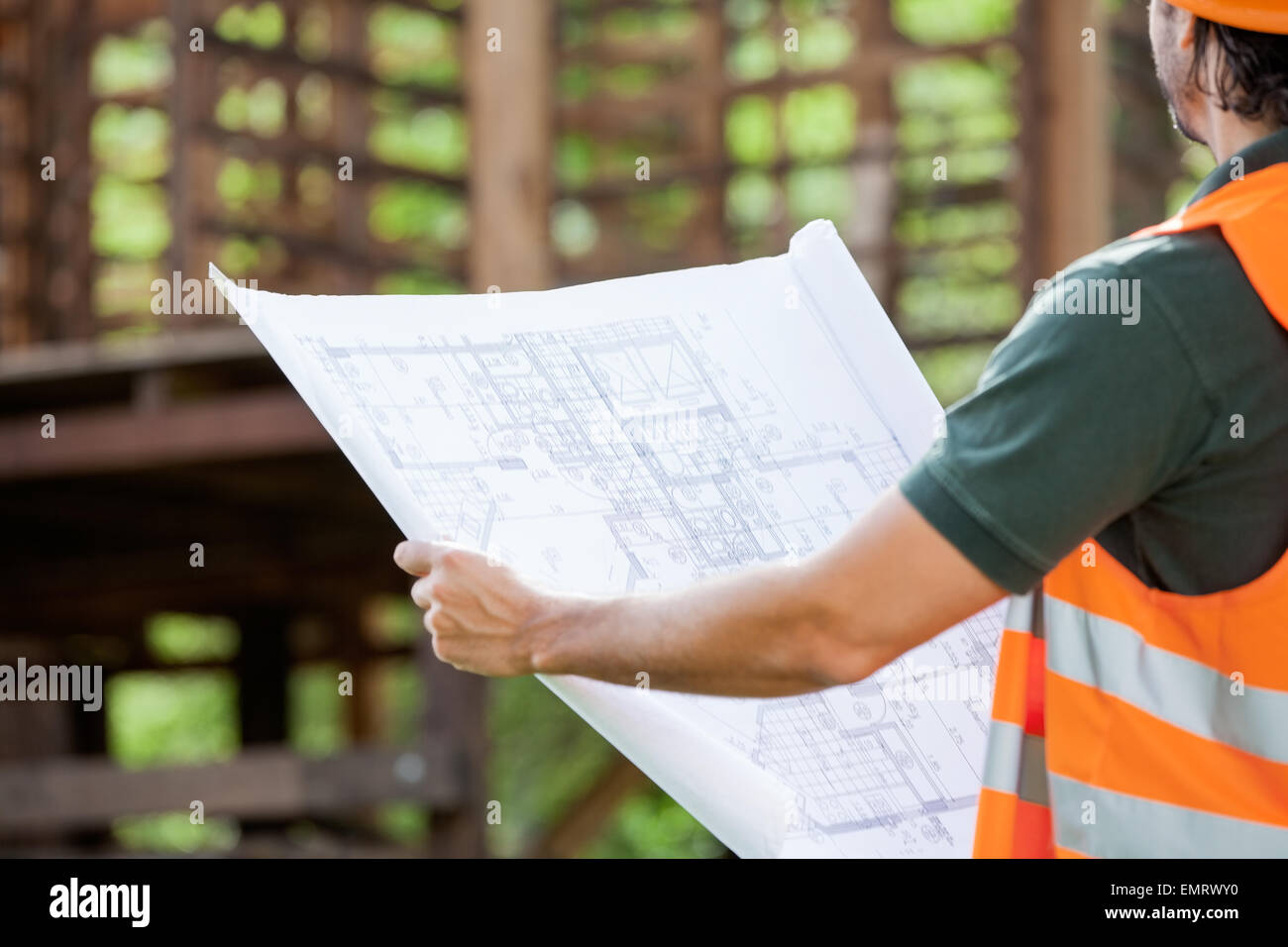 Architect Holding Blueprint At Construction Site Stock Photo - Alamy