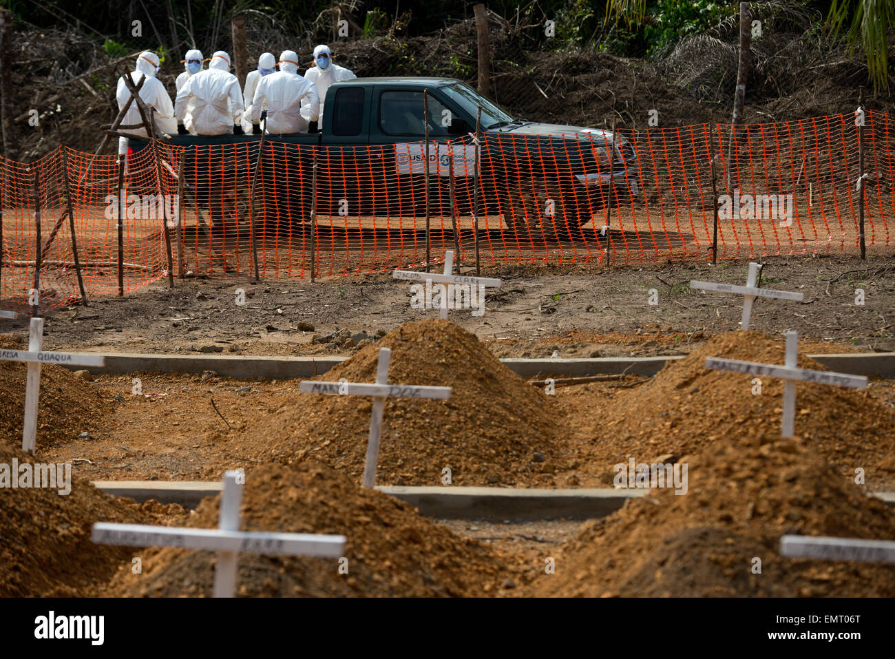 Liberian volunteer burial teams dig graves and bury victims of Ebola at