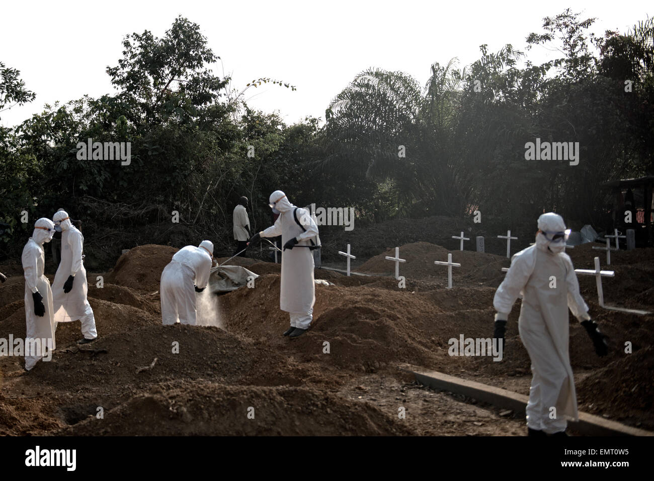 Liberian volunteer burial teams dig graves and bury victims of Ebola at Disco Hill Cemetery January 29, 2015 in Morgibi County, Liberia. Stock Photo