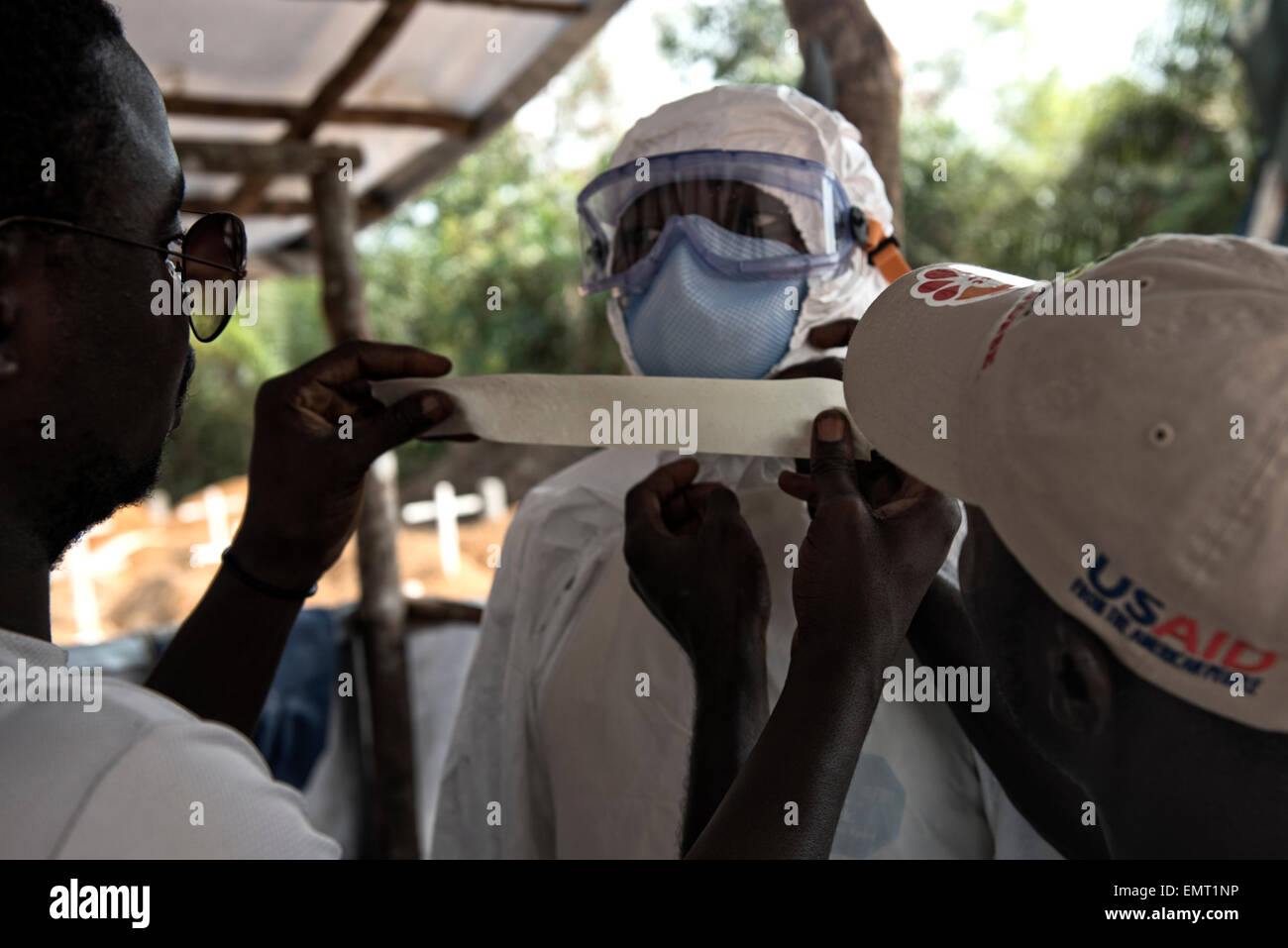 Liberian volunteer burial teams are carefully suited up in protective gear before dig graves to burry victims of Ebola at Disco Hill Cemetery January 29, 2015 in Morgibi County, Liberia. Stock Photo