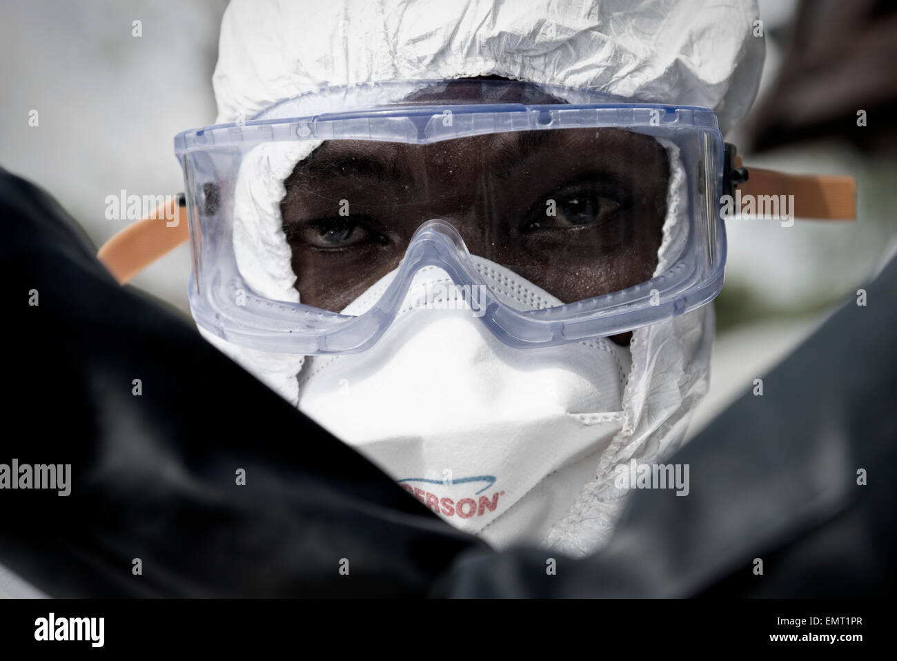 Liberian volunteer burial teams are carefully suited up in protective gear before dig graves to burry victims of Ebola at Disco Hill Cemetery January 29, 2015 in Morgibi County, Liberia. Stock Photo