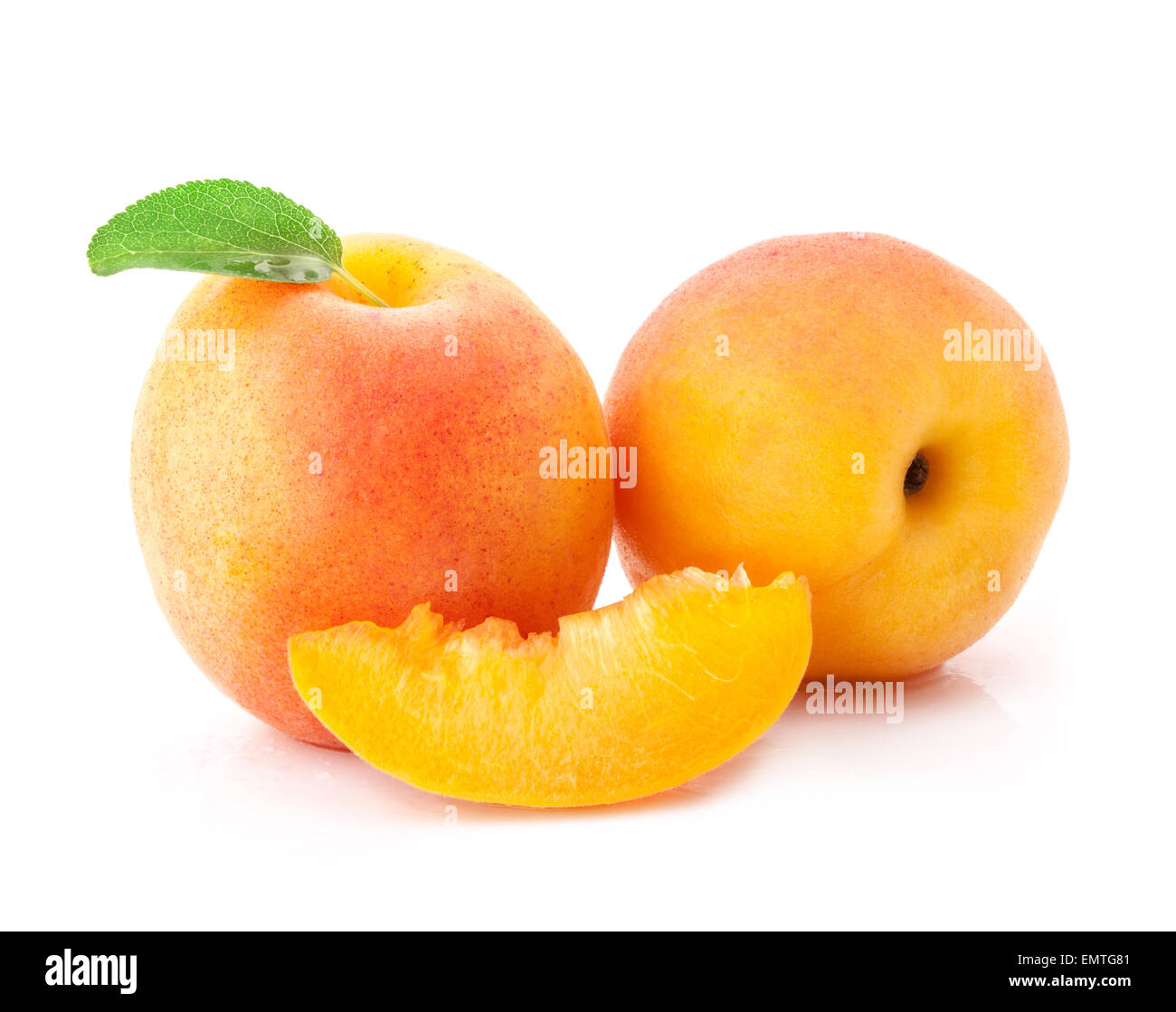 Apricot fruits and slices with green leaves, isolated on white