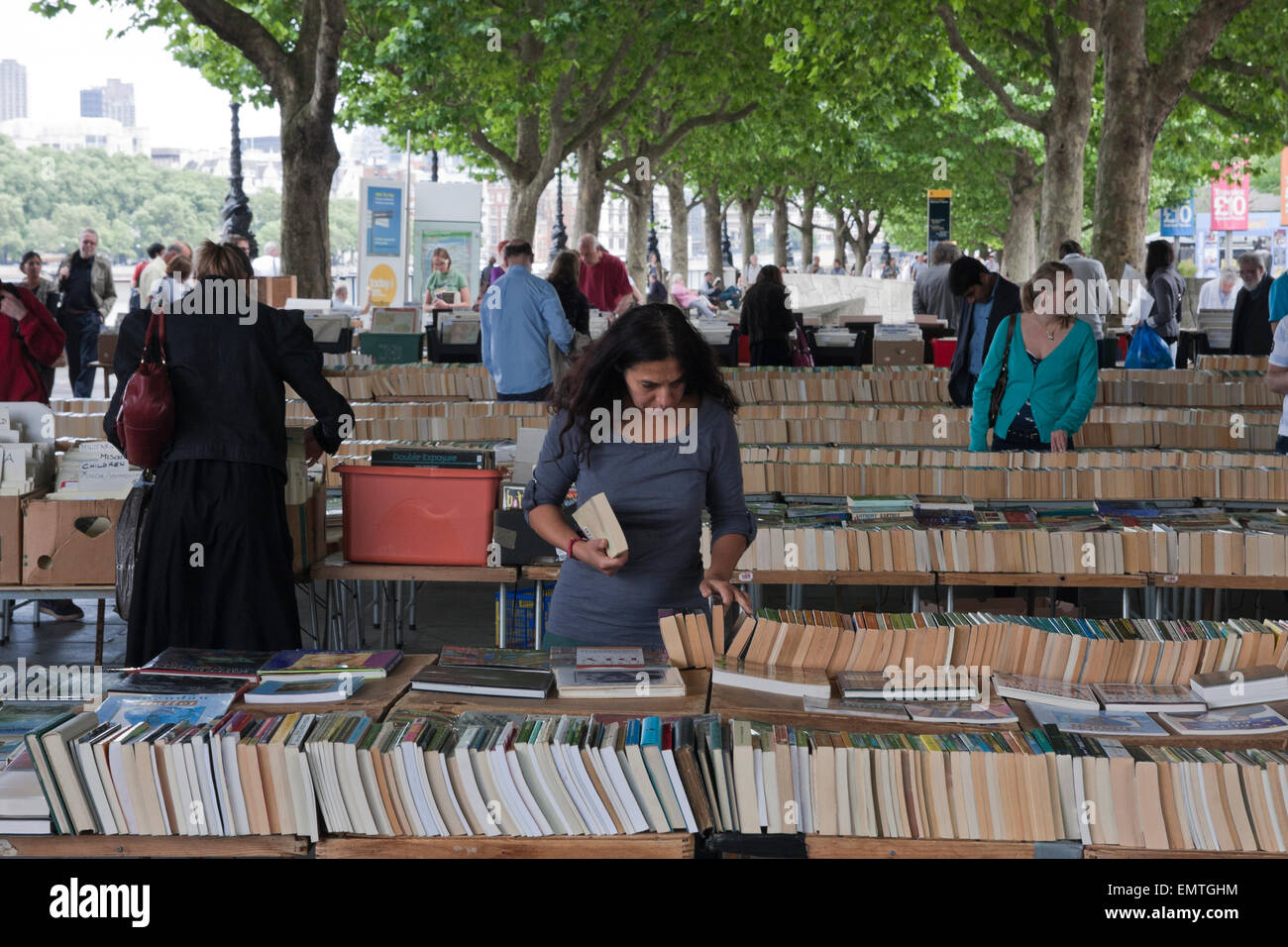 People browsing at a bookstall by the Thames in London Stock Photo