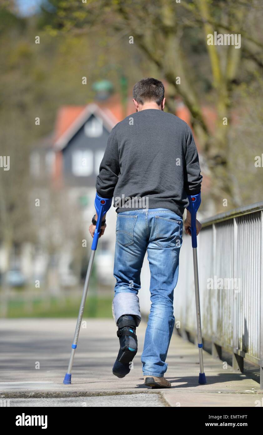 Man with crutches, Germany, city of Osterode, 15. April 2015. Photo: Frank May/picture alliance Stock Photo