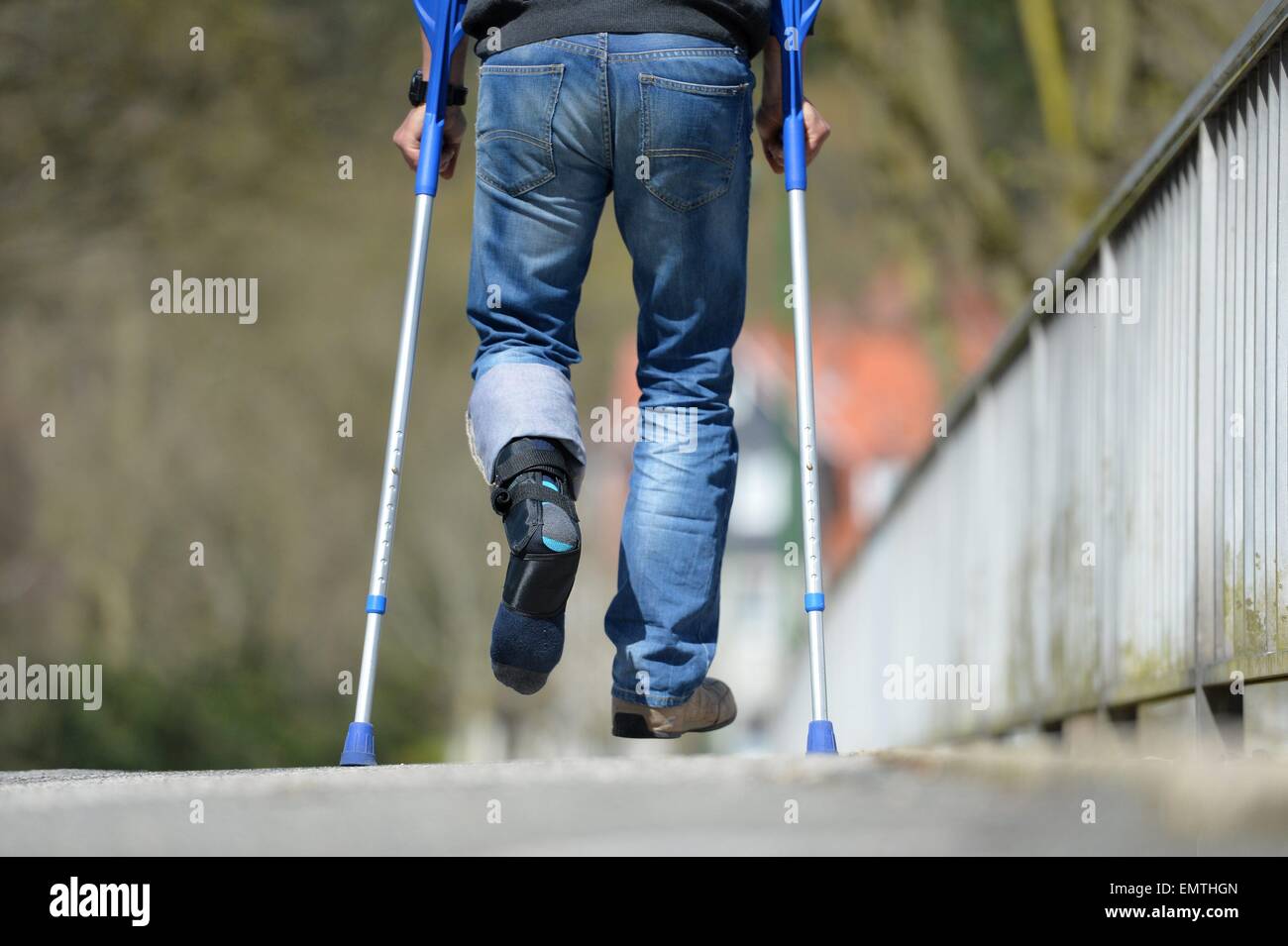 Man with crutches, Germany, city of Osterode, 15. April 2015. Photo: Frank May/picture alliance Stock Photo