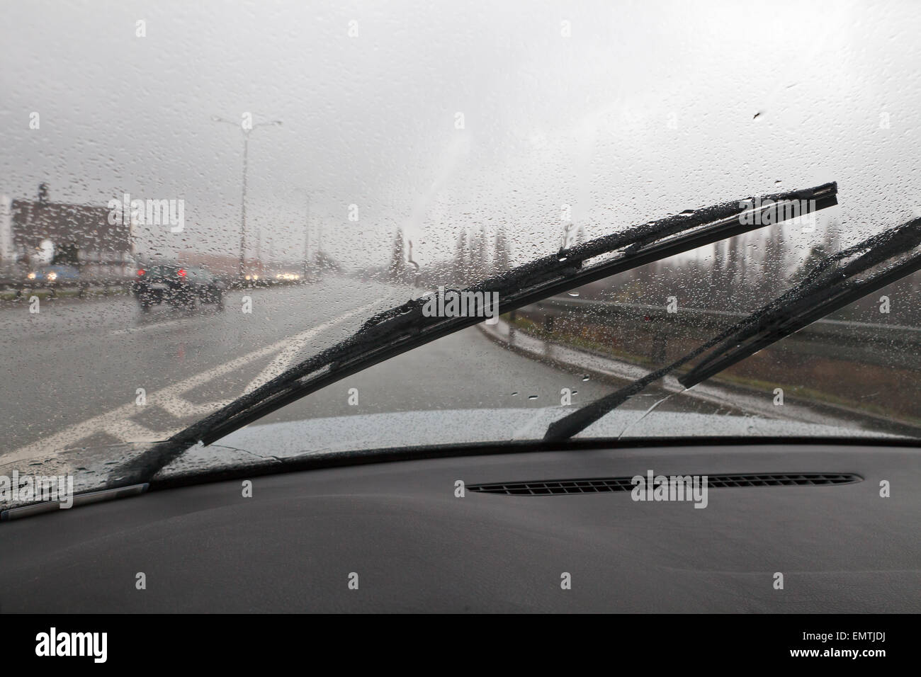 Bad weather conditions driving car, wipers working Stock Photo