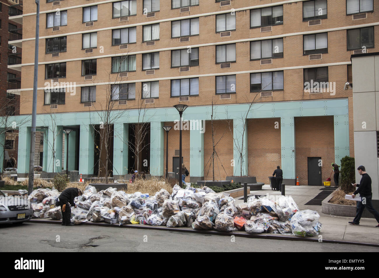 Recyclable garbage on the street in front of a high rise apartment