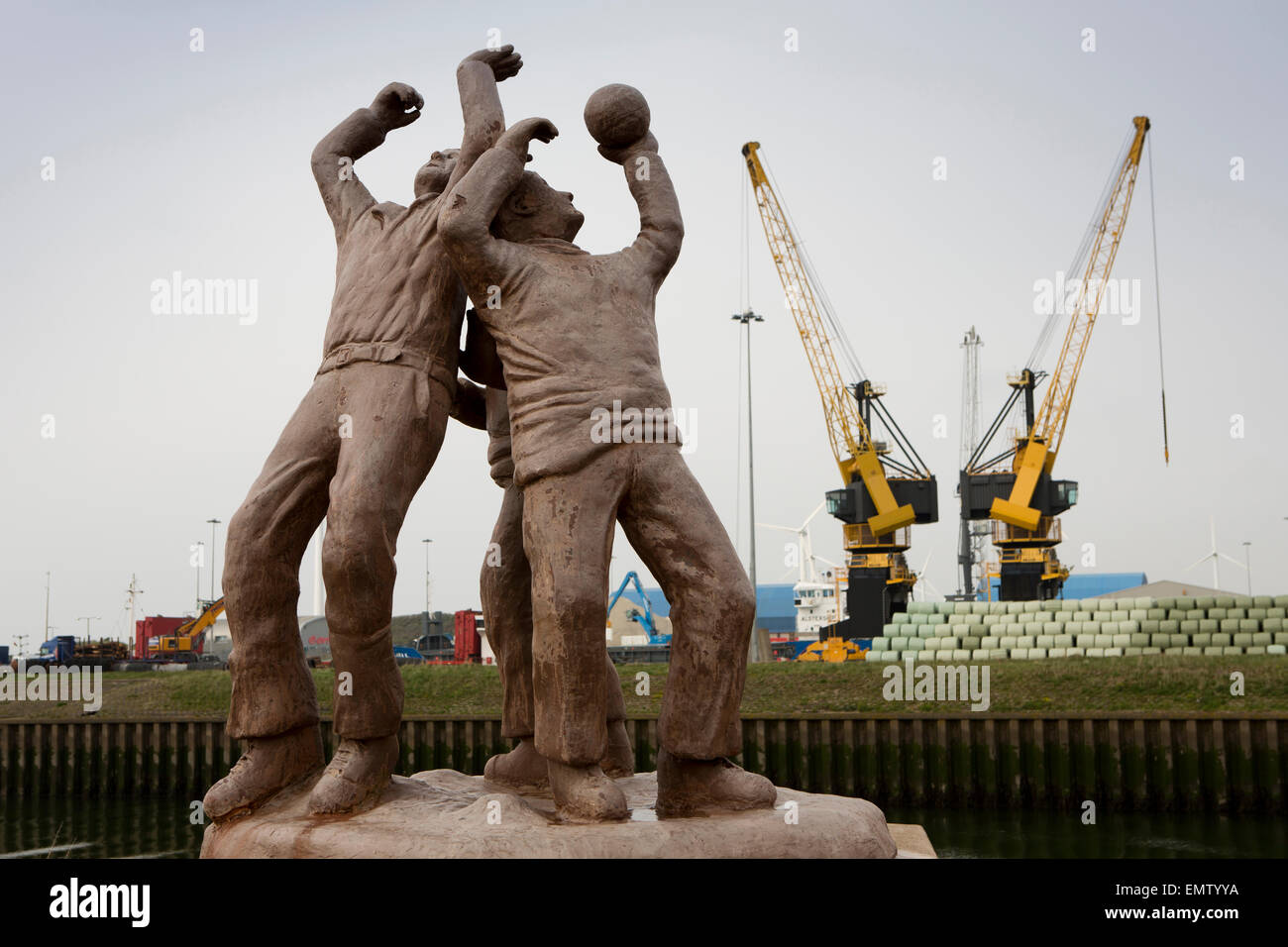 UK, Cumbria, Workington, harbour, Uppies and Downies traditional local ball game statue Stock Photo