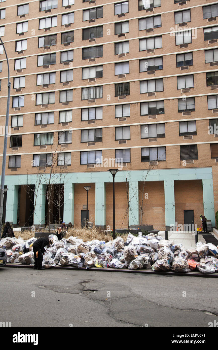 Recyclable garbage on the street in front of a high rise apartment