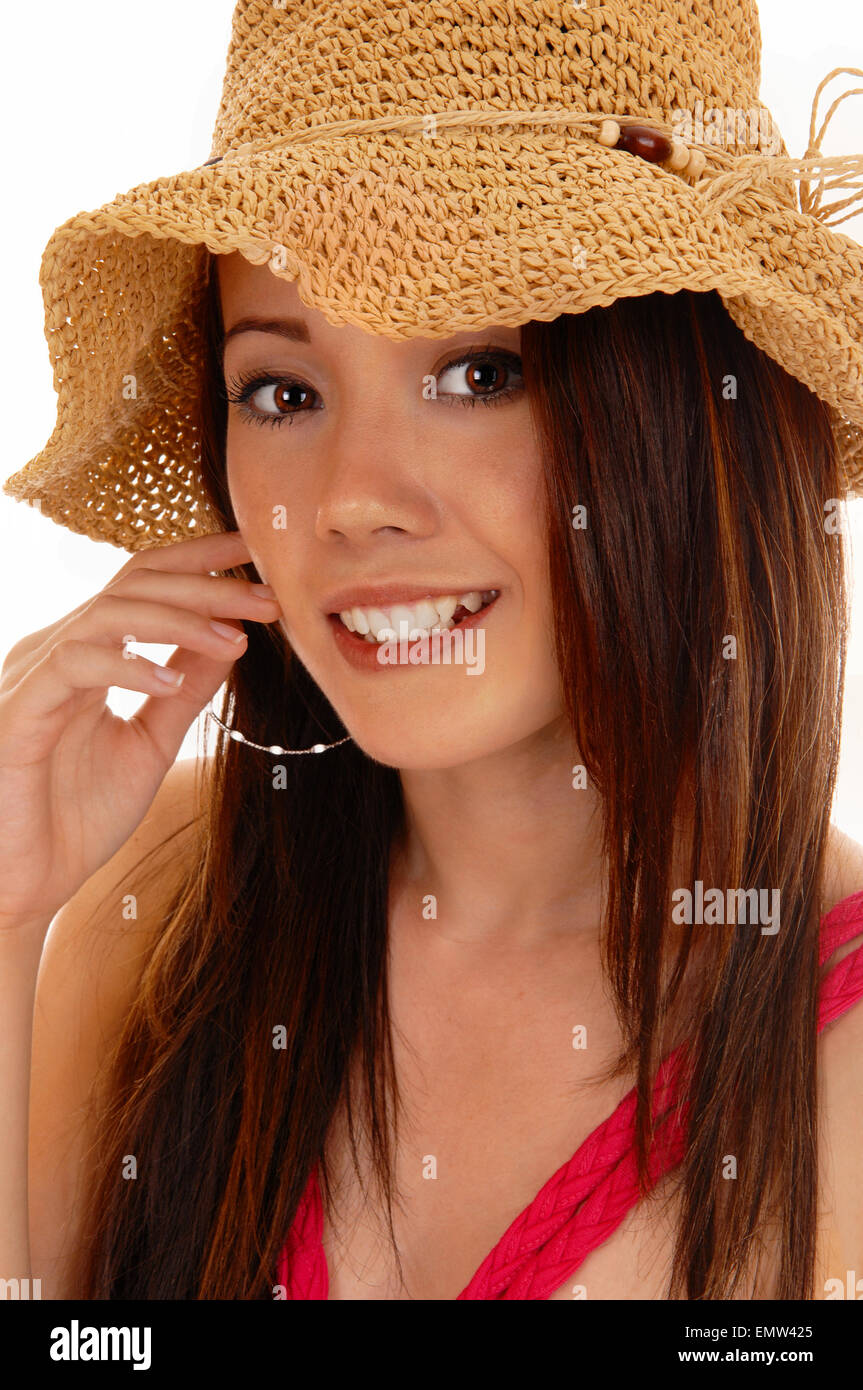 A portrait picture of a pretty young Asian woman wearing a beige straw ...