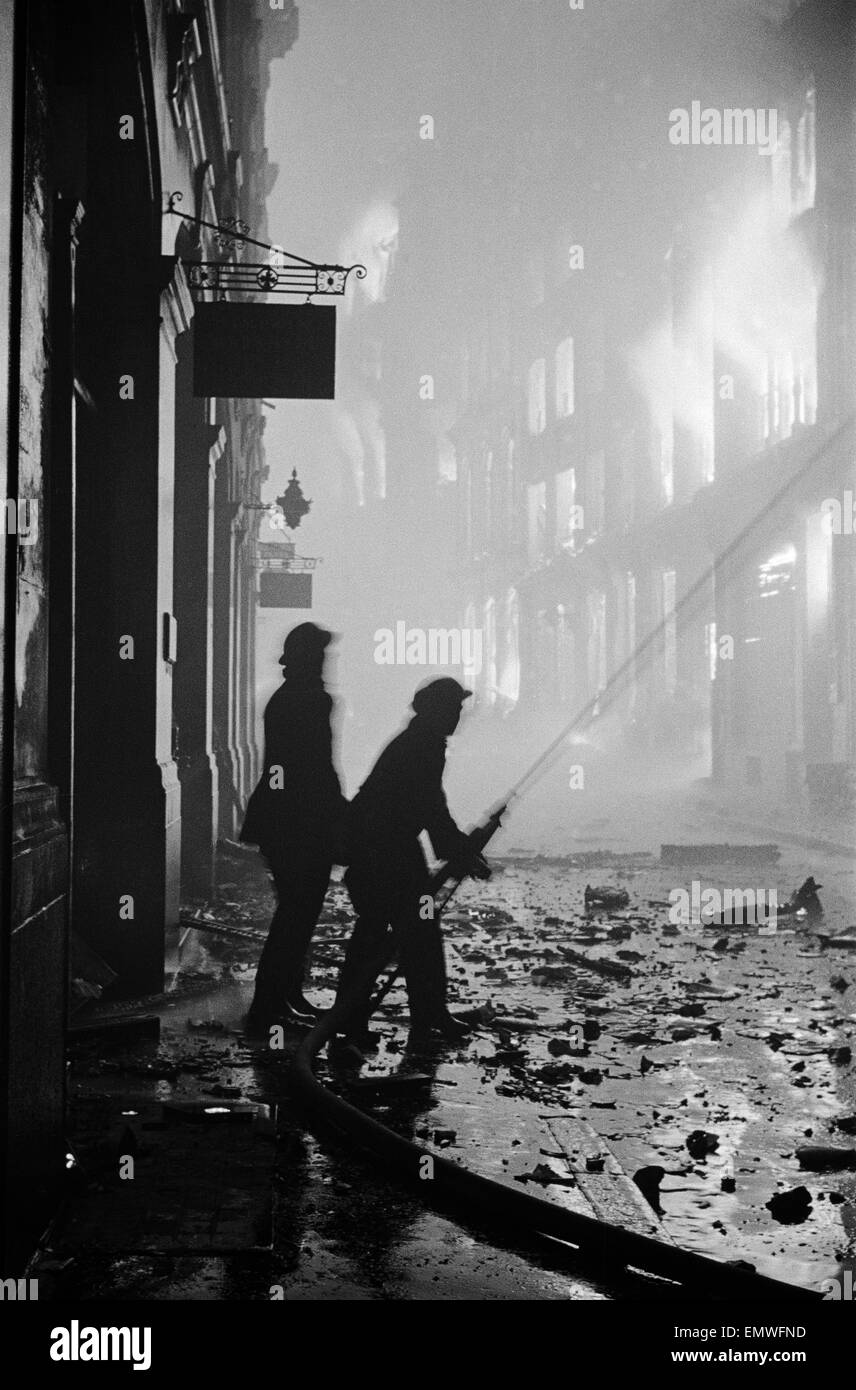 Firemen at work on Ave Maria Lane on the night of 29th December 1940. Stock Photo
