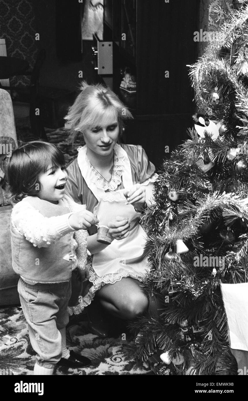 Model Janet Slaven seen here helping to dress a Christmas tree December 1985 Stock Photo