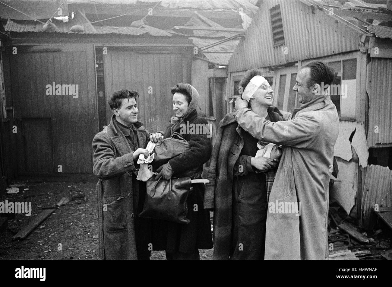 V2 Rocket incident at Brush Factory, High St, Waltham Cross. Factory girl smiling as she is bandaged up. 2nd January 1945 Stock Photo
