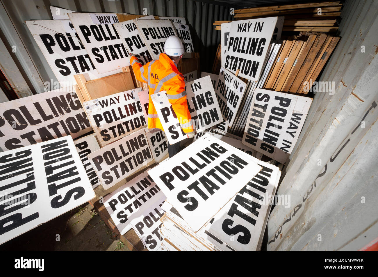 a council official sorts through polling signs and booths in Devon, in ...