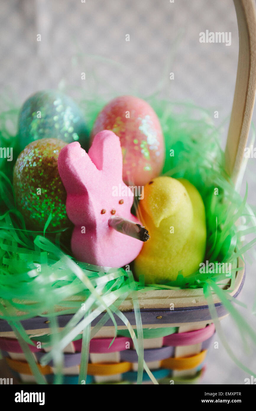 Easter sugar bunny smoking a joint in an easter basket. Stock Photo