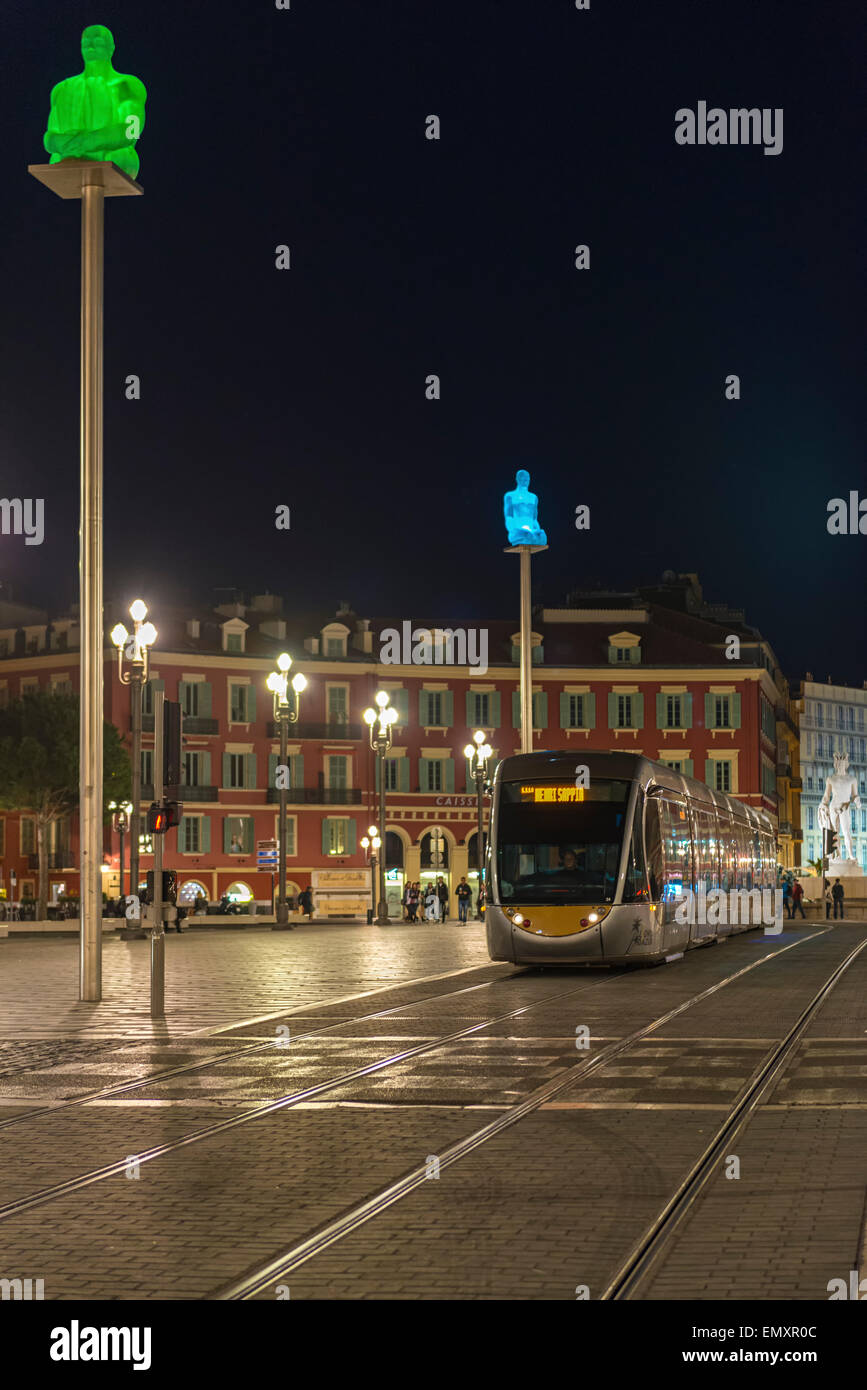 Tram makes its way through Place Massena in Nice at night Stock Photo