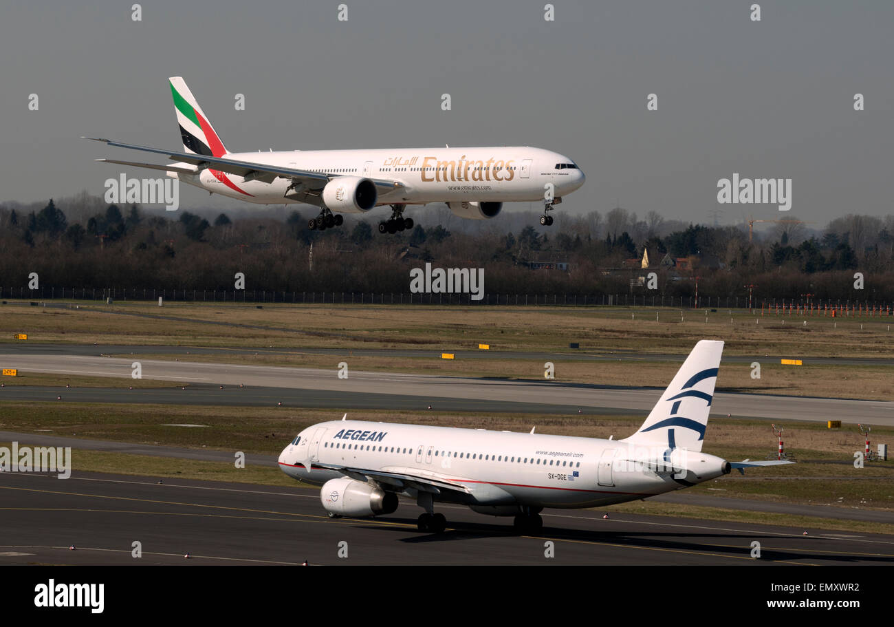Aegean Airbus A320 and Emirates Boeing 777-300, Dusseldorf Airport, Germany. Stock Photo