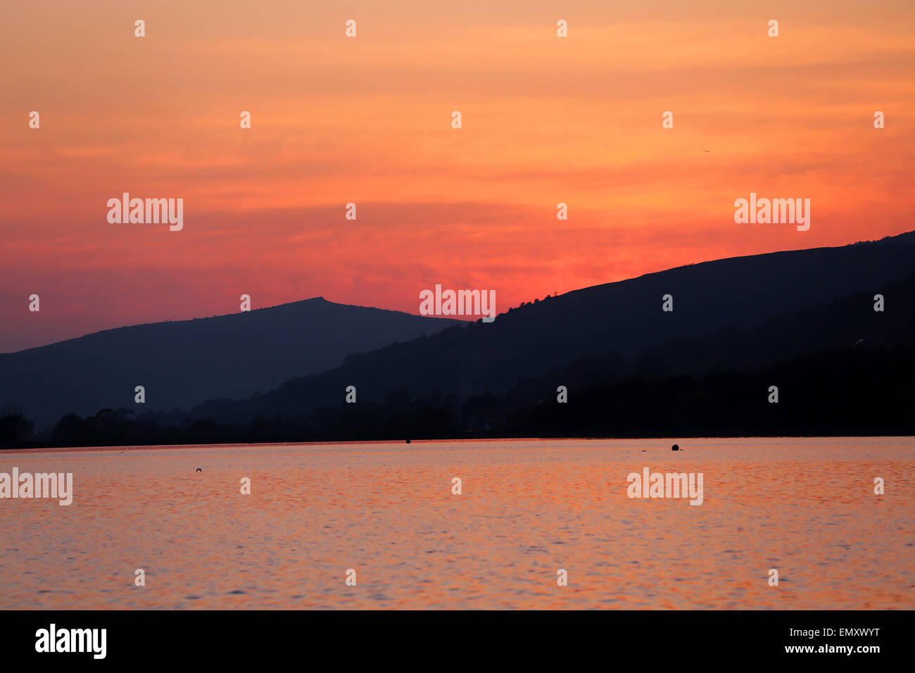 Sunset at Cheddar Reservoir with Crook peak in the back ground Stock Photo