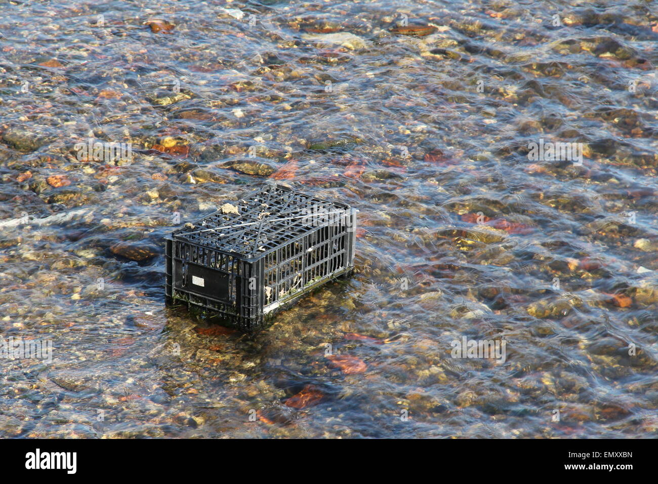 Dirty river pollution with plastic bag and toxic waste. Please care for the environment. Stock Photo