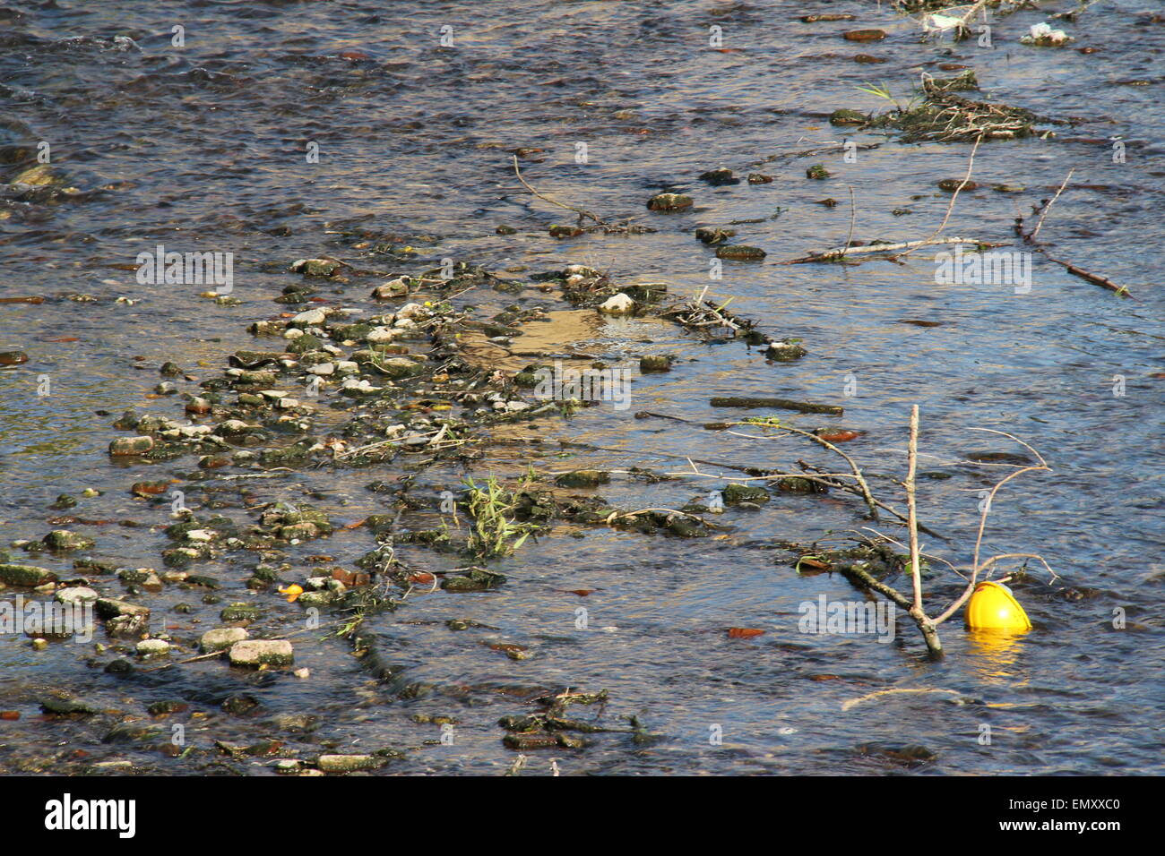 Dirty river pollution protective helmet for worker with  toxic waste. Please care for the environment. Stock Photo