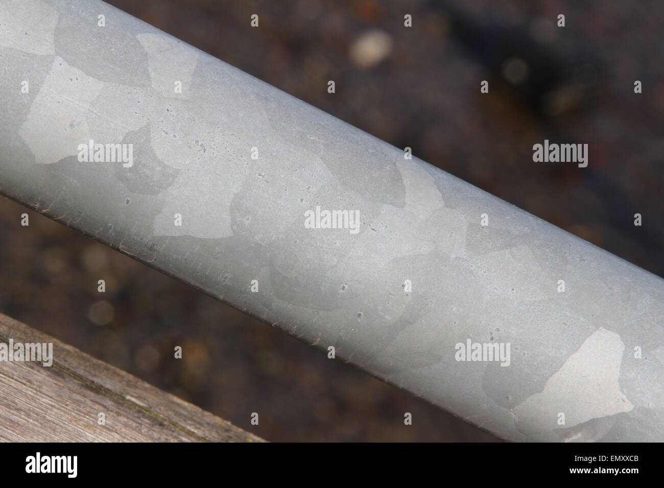 Steel pipe isolated on darker background. Stock Photo