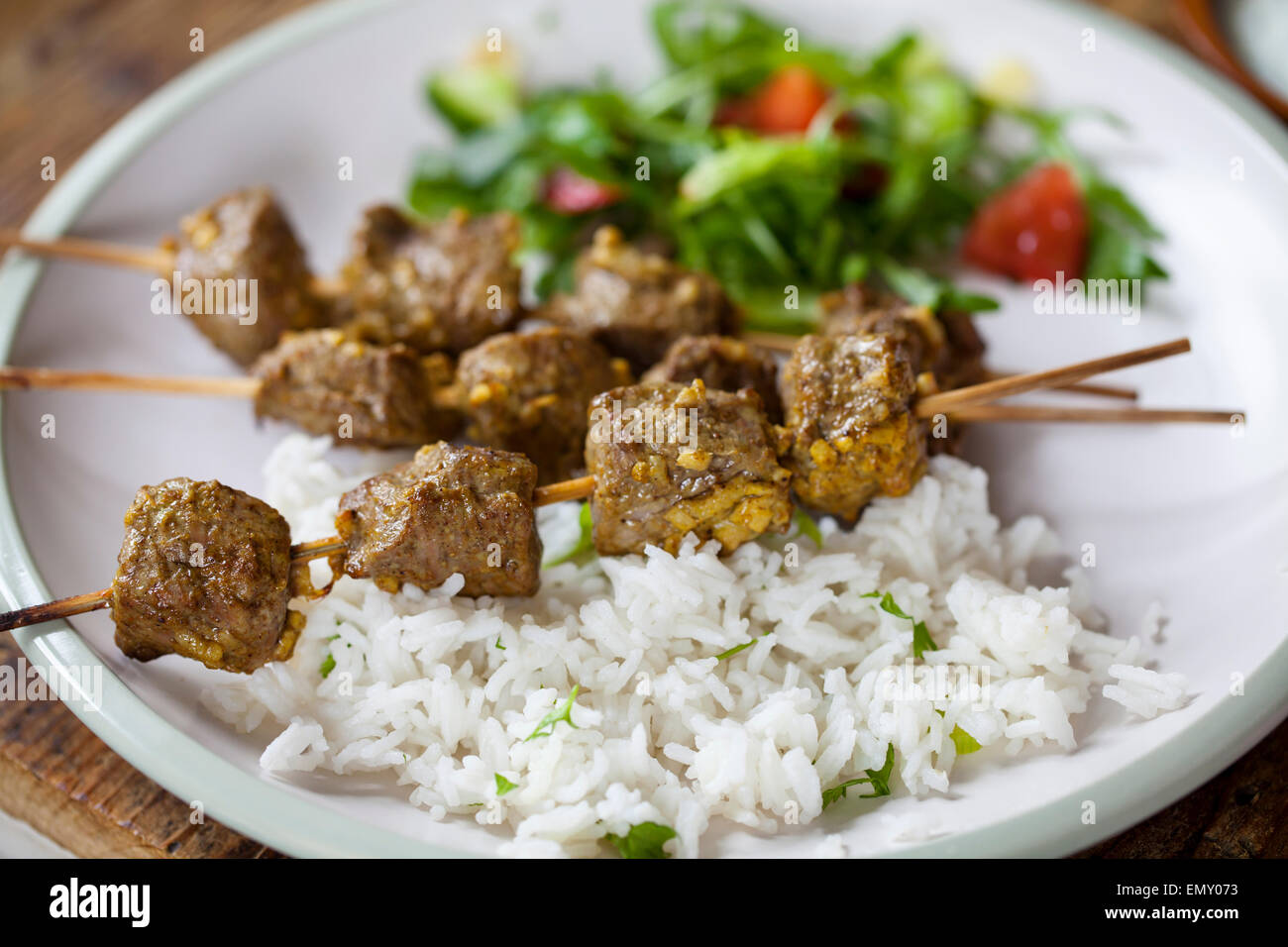Lamb kebab with rice and salad Stock Photo Alamy