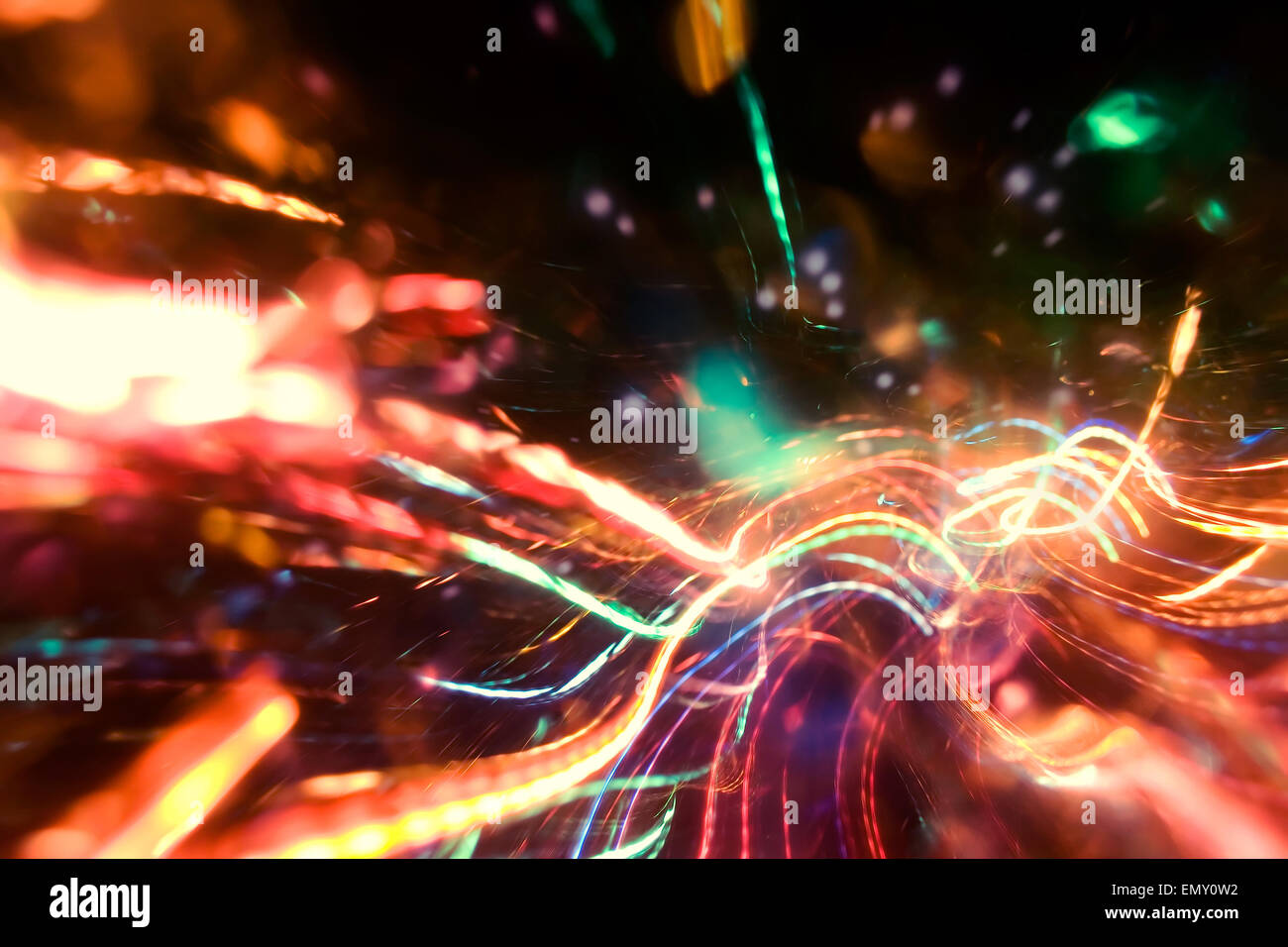 Abstract multicolored neon sparks in motion photo background effect. Stock Photo