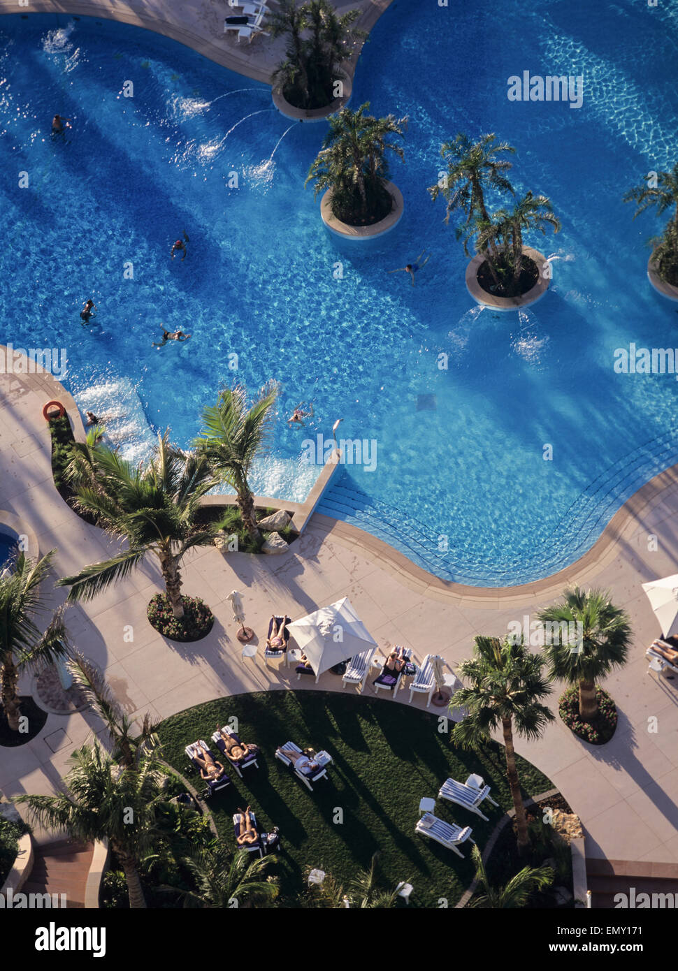 Aerial view of tourists sunbathing swimming in pool. Stock Photo