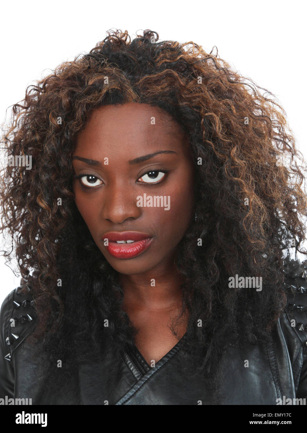 Glamorous Black woman in a black leather jacket with wild hair and piercing eyes Stock Photo
