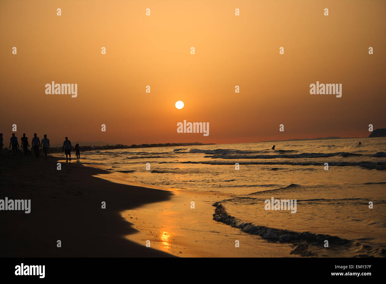Golden sunset view on the beach Stock Photo - Alamy