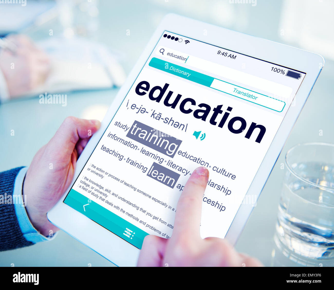 Man Reading the Definition of Education Stock Photo