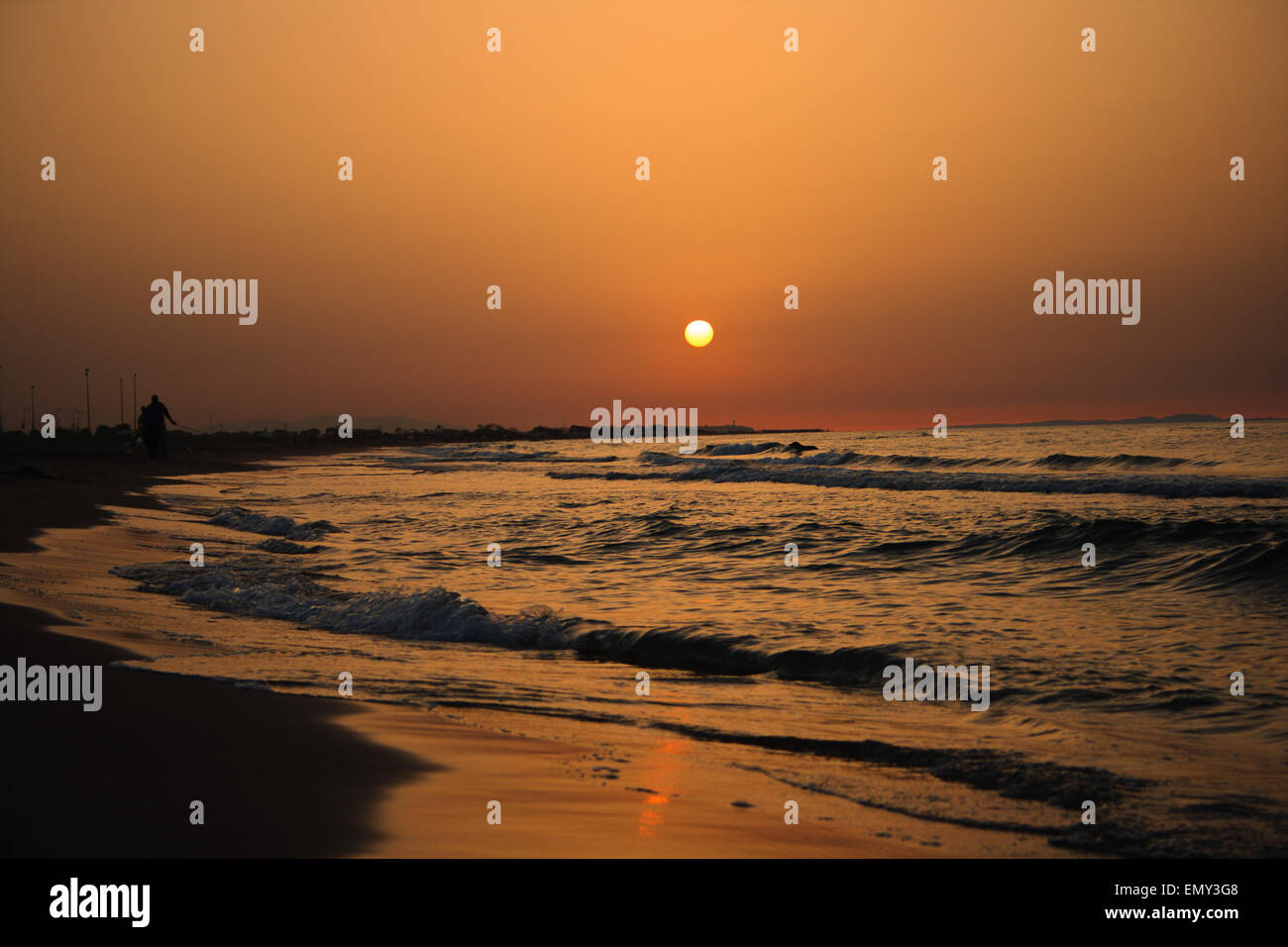 Golden sunset view on the beach Stock Photo - Alamy