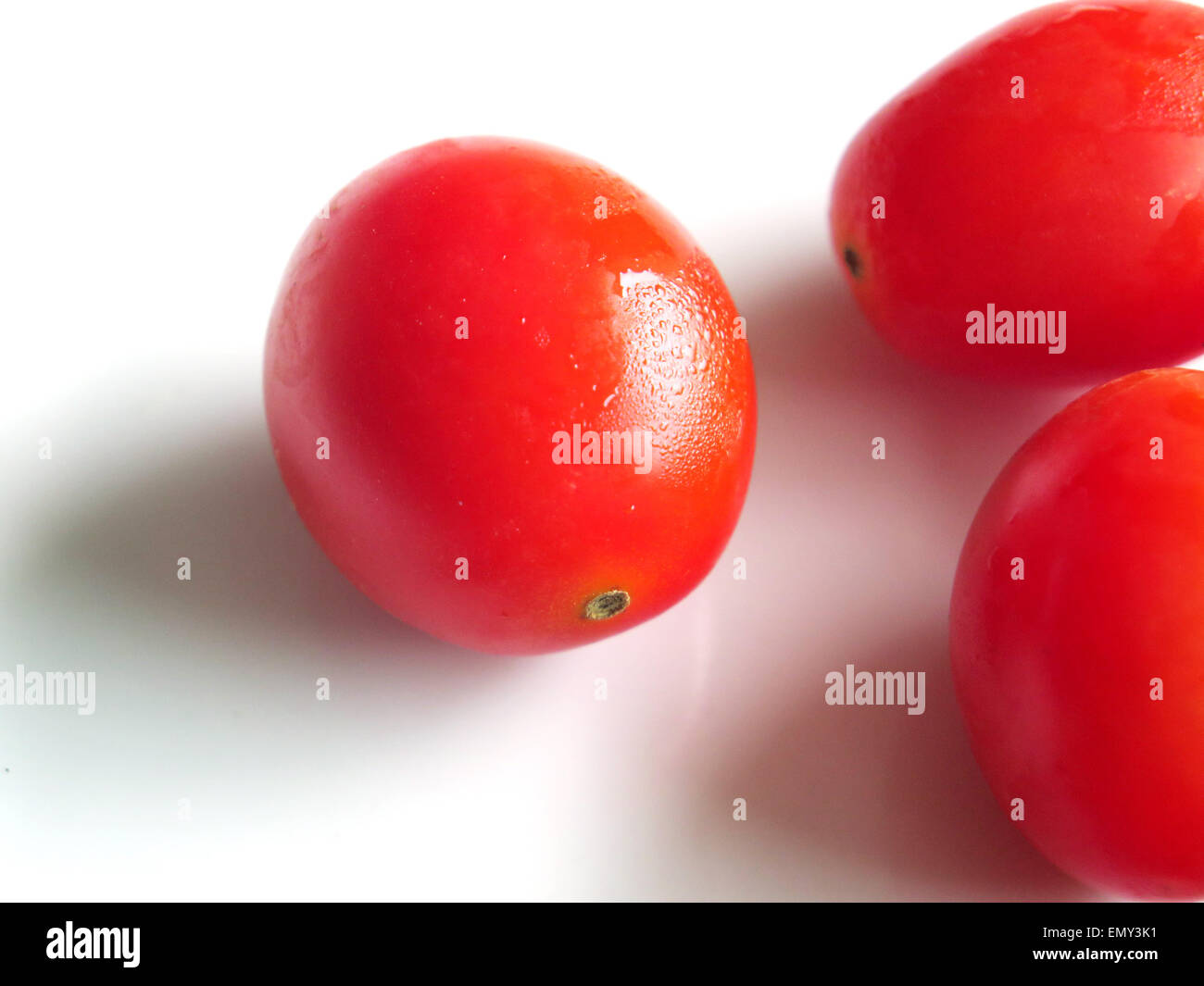 fresh cherry tomatoes on white background Stock Photo - Alamy