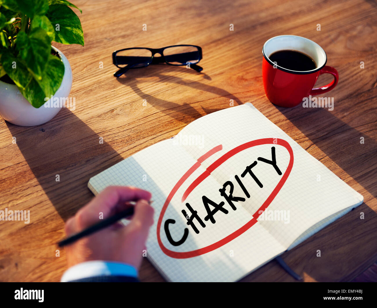 Man with Note Pad and Charity Concepts Stock Photo