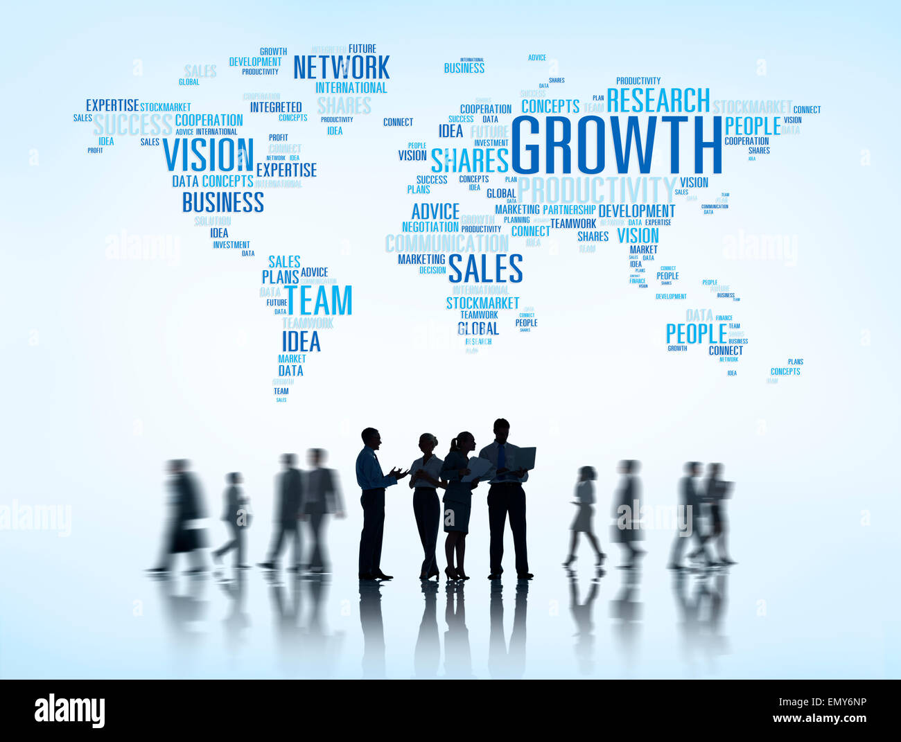 Silhouettes of Business People Working and Global Business Themed World Above Stock Photo