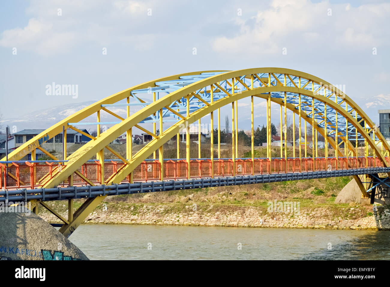 Colorful steel bridge for pedestrians over a small river Stock Photo