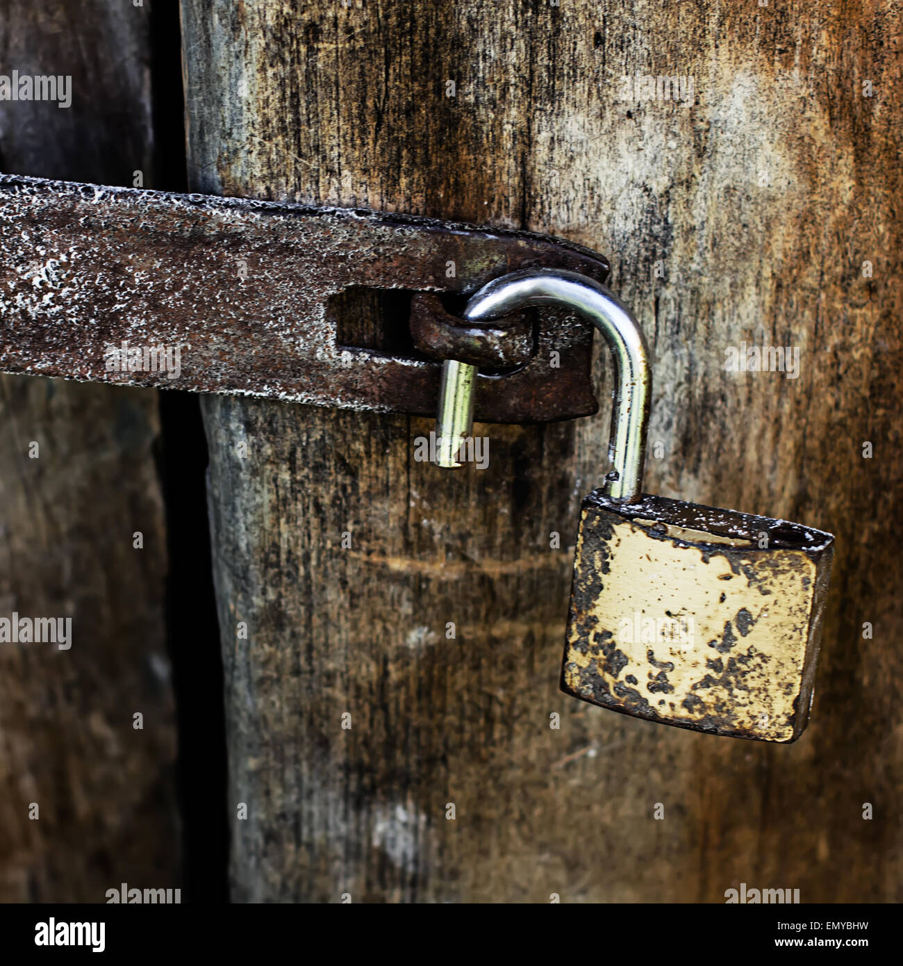 Old Rusty Padlock Open on wooden door Stock Photo - Alamy