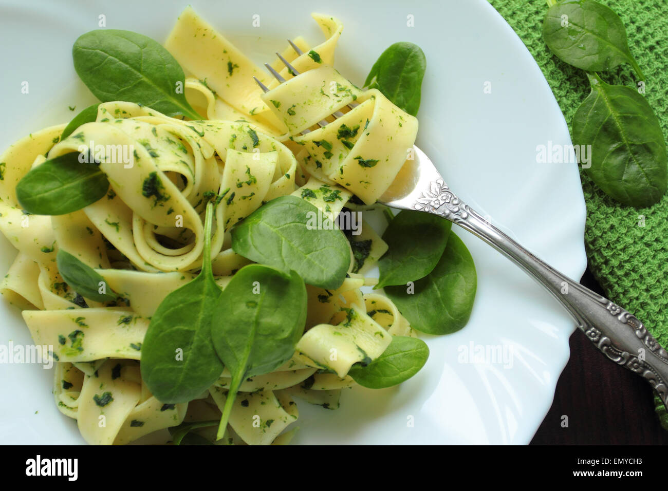 Pappardelle pasta with fresh spinach on white plate Stock Photo