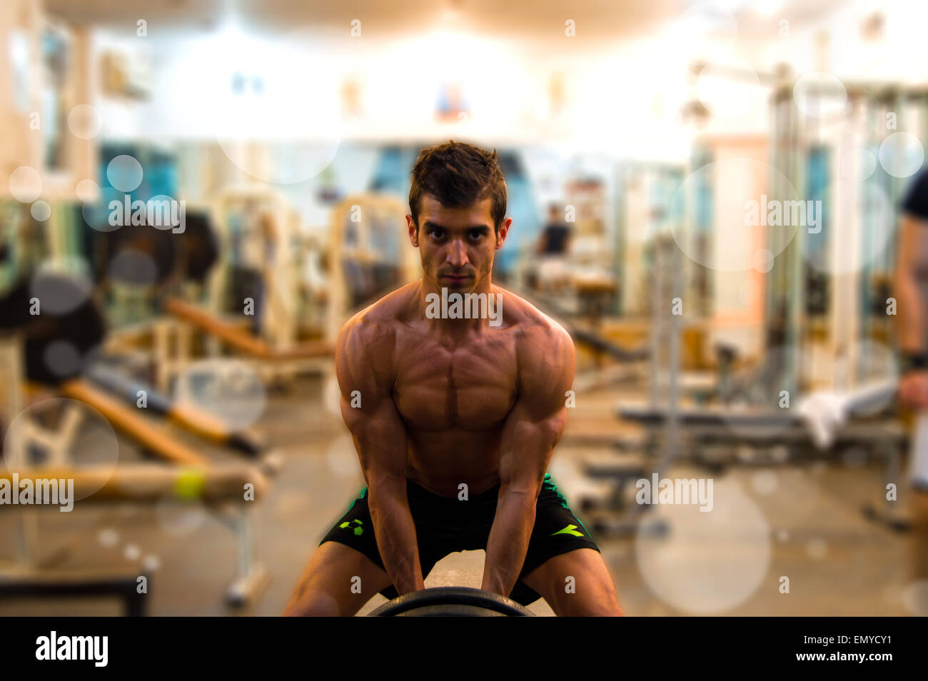 Bodybuilder Lifting Weightlifting Bar At Rusty Gym Stock Photo