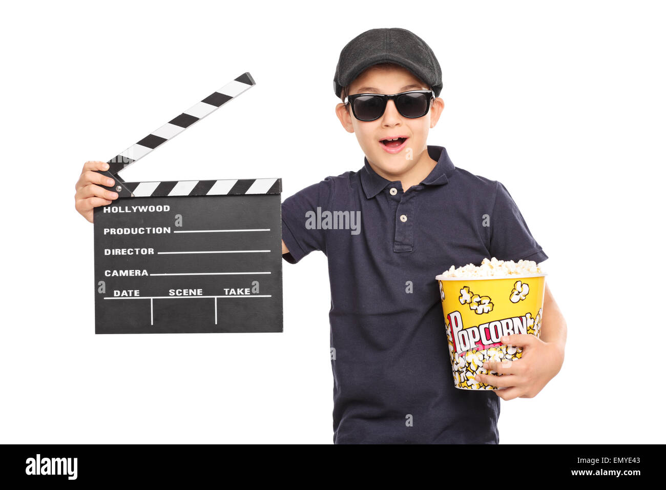 Little kid with a beret and sunglasses holding a box of popcorn and a movie clapperboard isolated on white background Stock Photo