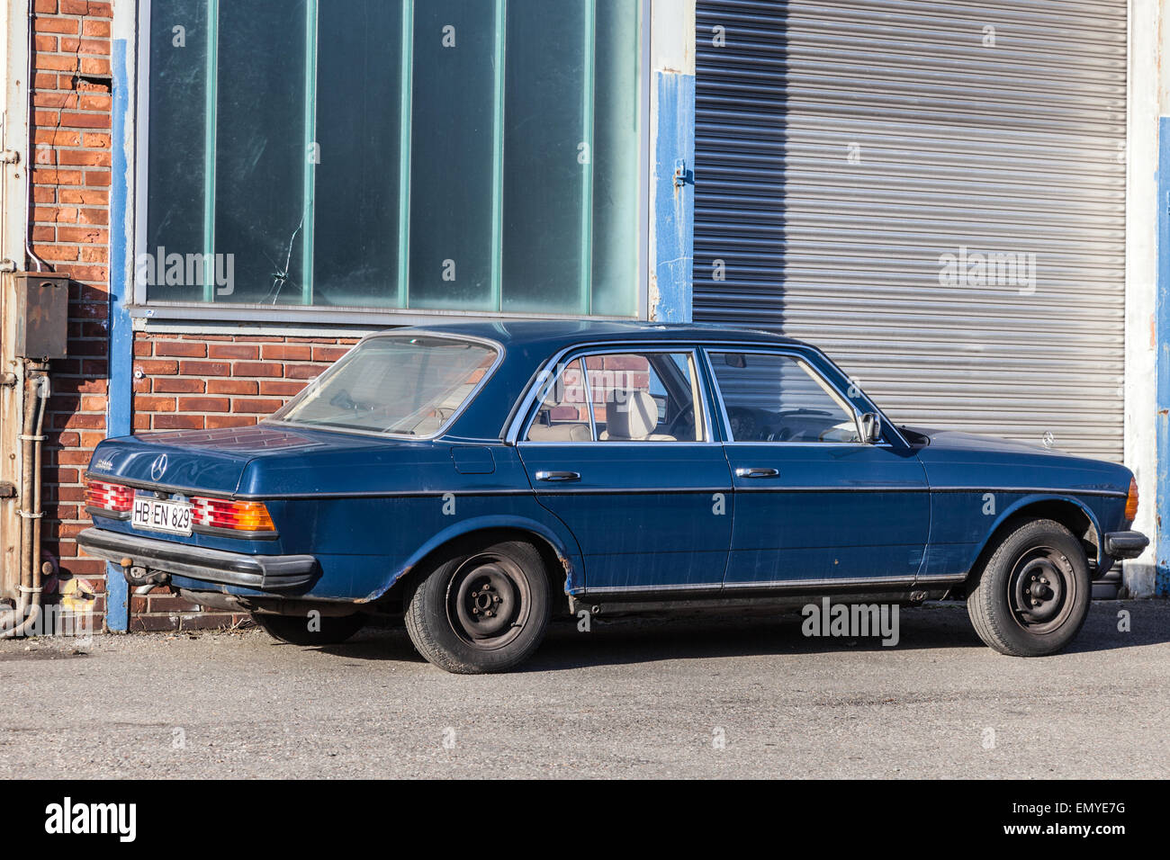 Old Mercedes Benz W123 parked in the industrial park in Bremen, Germany Stock Photo